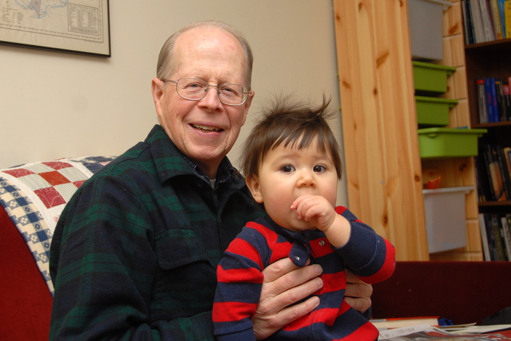 Grandpa holds Peter on couch