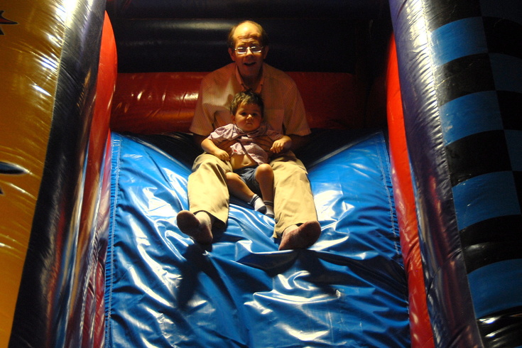 Daddy takes Peter down the bouncy slide