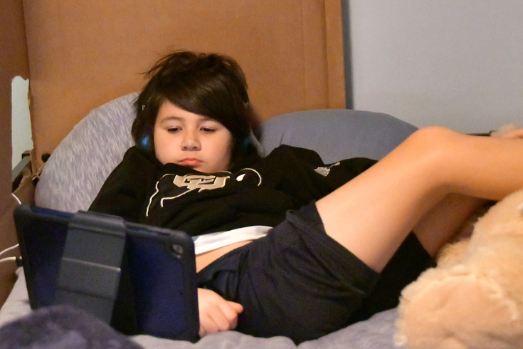 lounging in bed with the devices