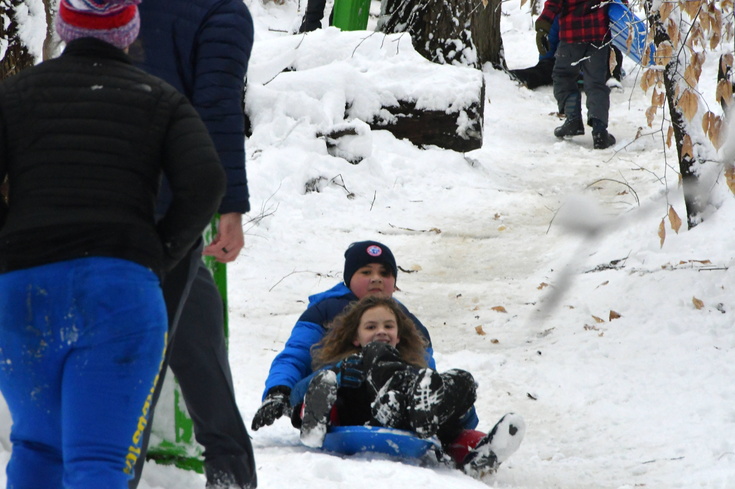 with Adam sledding in a crowd