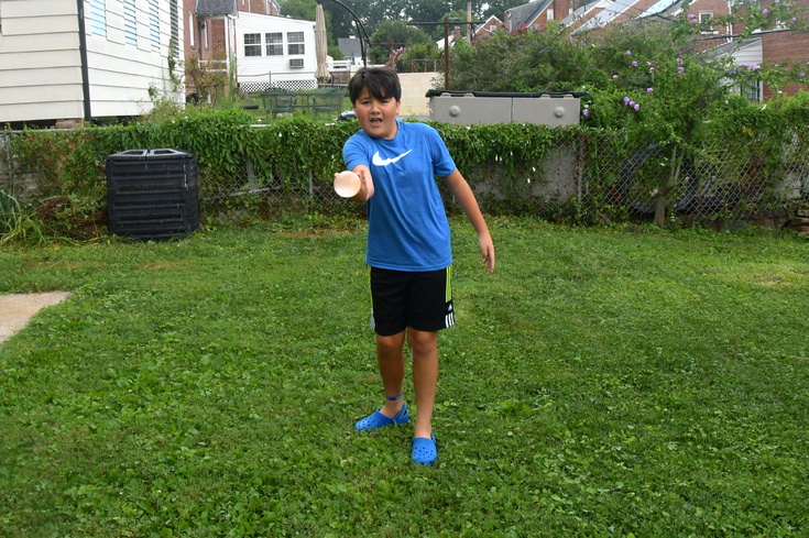 tossing a water balloon